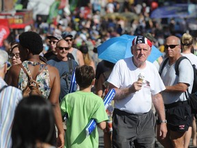 Crowds enjoy the heat on the last day of the fair at the PNE in Vancouver on Monday.