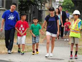 Parents and children arrive at Renfrew Elementary in Vancouver Tuesday for the first day of school. Elementary school enrolment in Vancouver and Richmond has declined in the past five years.