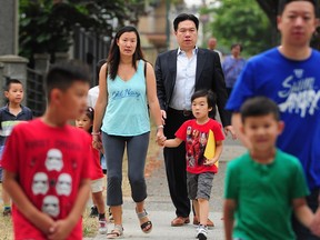 FILE PHOTO - Parents and children arrive at Renfrew Elementary School for the first day of school in Vancouver, BC., September 5, 2017.