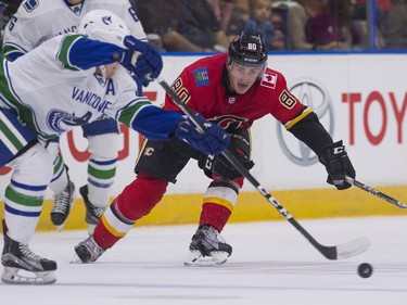 Calgary Flames Glenn Gawdin (right) pressures Vancouver Canucks Olli Juolevi