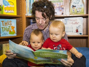 Mike Acevedo, with Montgomery and Alexander, at Raise-A-Reader literacy program at Vancouver Public Library's central branch.