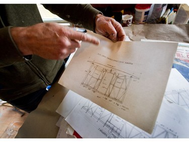 Jeremy holding drawings he's done of the original craftmanship.