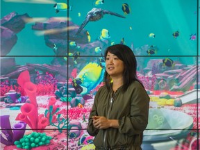 NGX Interactive producer Hanna Cho in front of the  virtual aquarium in the lobby of the emergency department at the new Teck Acute Care Centre at B.C. Children's Hospital.