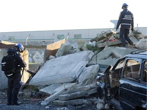 File photo of Search and rescue workers probe a pile of concrete and debris during a training exercise in Vancouver.