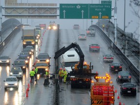 Work crews are out in force to fix the centre median on the Ironworkers Memorial Bridge after a truck crashed into it, while traffic is routed around the accident scene. That bridge to the North Shore sees three to four collisions per week, causing traffic to stop or crawl on the highway and clogging feeder routes.