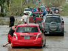 Residents drive through a flooded road after the passing of Hurricane Maria, in Toa Baja, Puerto Rico, Friday, Sept. 22, 2017.