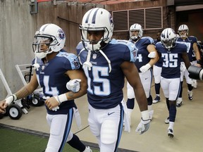 Tennessee Titans wide receiver Eric Weems (14) and wide receiver Darius Jennings (15) walk to the field with arms linked after the national anthem before a game against the Seattle Seahawks on Sept. 24.