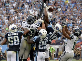 Seattle Seahawks tight end Jimmy Graham (88) and wide receiver Tyler Lockett (16) reach for a pass with Tennessee Titans defenders in the end zone during the second half of an NFL football game, Sunday, Sept. 24, 2017, in Nashville, Tenn.