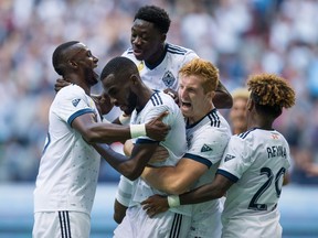 Vancouver Whitecaps' Bernie Ibini, from left, Tony Tchani, Alphonso Davies, Tim Parker and Yordy Reyna celebrate Tchani's tying goal against the Columbus Crew during the second half of an MLS soccer game in Vancouver, B.C., on Saturday September 16, 2017.