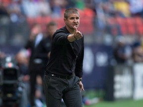Vancouver Whitecaps head coach Carl Robinson gets fired up on the sidelines, arguing a call with the referee during an MLS game. The Caps’ bench boss has his club in first place in the Western Conference with the ninth highest payroll, at least going by the players’ union salary figures from last April.