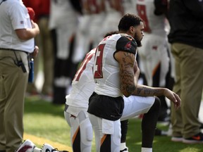 Tampa Bay Buccaneers wide receivers Mike Evans (13) and DeSean Jackson kneel during the national anthem before a game against the