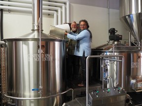 Vikram Vij, right, with Trading Post brewer Tony Dewald.