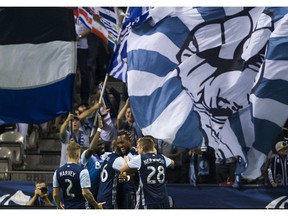 Kendall Watson is mobbed by his Vancouver Whitecaps teammates after scoring against Real Salt Lake in Saturday's game at B.C. Place.