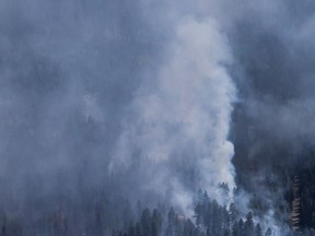 A wildfire is seen from a Canadian Forces Chinook helicopter as Prime Minister Justin Trudeau views areas affected by wildfire near Williams Lake on July 31, 2017. A community group in the town is concerned about further air-quality woes if an incinerator goes ahead with a plan to burn used rail ties.