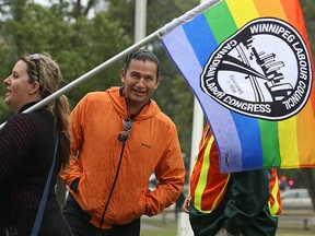 Wab Kinew sticks his head out prior to the start of the Winnipeg Labour Day march from Memorial Park on Mon., Sept. 4, 2017.