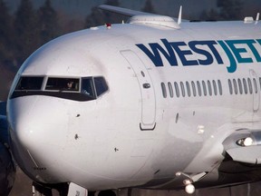 Dozens of flights out of Vancouver and other airports in Western Canada were delayed Saturday because of "a significant IT outage" at WestJet.