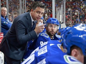 Head coach Travis Green of the Vancouver Canucks looks on from the bench during their NHL game against the Winnipeg Jets at Rogers Arena on Oct. 12.