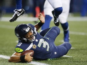Quarterback Russell Wilson of the Seattle Seahawks reaches into the end zone to score a 23 yard touchdown against the Indianapolis Colts in the third quarter of the game at CenturyLink Field on October 1, 2017 in Seattle, Washington.