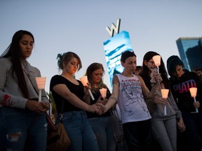 Mourners attend a candlelight vigil at the corner of Sahara Avenue and Las Vegas Boulevard for the victims of Sunday night's mass shooting, October 2, 2017 in Las Vegas, Nevada.