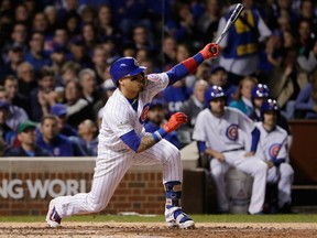 Javier Baez of the Cubs hits a home run in the fifth inning against the Los Angeles Dodgers during Game 4 of the National League Championship Series at Wrigley Field in Chicago on Wednesday night.