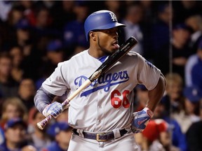 Yasiel Puig of the Los Angeles Dodgers licks his bat while at the plate in the third inning of Game 5 of the National League Championship Series against the Chicago Cubs at Wrigley Field in Chicago on Oct. 19, 2017.