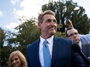 Arizona Sen. Jeff Flake and his wife Cheryl Flake (left) leave the U.S. Capitol as they are trailed by reporters on Oct. 24, 2017 in Washington, D.C. Flake announced that he will not be seeking re-election and will leave the Senate after his term ends in 14 months.