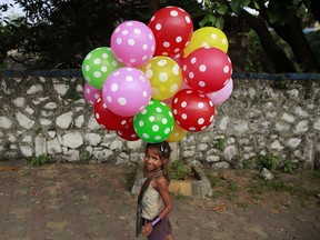 Lali carries balloons to sell on a beach in Mumbai, India, in October 2015. The UN General Assembly marks Oct. 11 as the International Day of the Girl Child, to recognize girls' rights and the unique challenges girls face around the world.