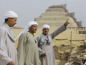 Archaeology workers, with the step pyramid of Saqqara (under restoration at the time) in the background, in May 2014.