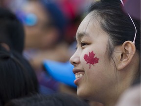 Census shows Caucasians are the “visible minority” in Richmond, Surrey, Burnaby, Coquitlam and the city of Vancouver. as well as Greater Toronto. (PHOTO - A woman sports a maple leaf at the Canada Day celebrations at Canada Place, Vancouver.