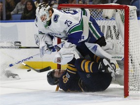 Ryan O'Reilly of the Sabres collides with Vancouver Canucks' goalie Jacob Markstrom during Friday's NHL game in Buffalo. Markstrom kept most pucks and O'Reily out of his net as the visitors recorded a 4-2 win.