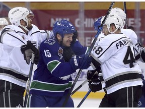 Andy Andreoff, Oscar Fantenberg, Derek Dorsett The Los Angeles Kings' Andy Andreoff, left, and Oscar Fantenberg, right, and the Vancouver Canucks' Derek Dorsett fight during the first period of an NHL China exhibition game at the Cadillac Arena in Beijing, Saturday, Sept. 23, 2017. (AP Photo/Mark Schiefelbein) ORG XMIT: XMAS103 Mark Schiefelbein, AP