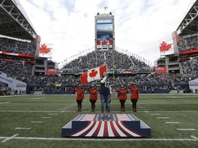 Arielle Tuliao sings the Canadian national anthem at CenturyLink Field before an NFL football game between the Seattle Seahawks and the Indianapolis Colts, Sunday, Oct. 1, 2017, in Seattle.