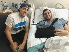 Sheldon Mack, right, poses for a photo with the off-duty paramedic Jimmy Grovom from his hospital bed in Las Vegas on Wednesday Oct.5, 2017. Mack was shot in the forearm and abdomen Sunday when a lone gunman opened fire killing nearly 60 people and injuring about 500.