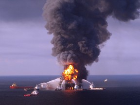 This file photo taken on April 22, 2010 shows a U.S. Coast Guard image first released on April 22, 2010 of fire boat response crews as they battle the blazing remnants of the off shore oil rig Deepwater Horizon April 21, 2010.
