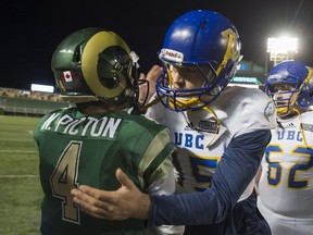 UBC Thunderbirds quarterback Michael O'Connor (right) is congratulated by University of Regina Rams quarterback Noah Picton after U Sports Canada West playoff football action at Mosaic Stadium at Taylor Field, Regina, on November, 5, 2016.