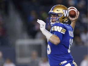 Winnipeg Blue Bombers quarterback Matt Nichols looks for his receivers during the first half of CFL action against the Hamilton Tiger-Cats in Winnipeg on Oct. 6, 2017. Even if wet weather forces Matt Nichols to take the glove off his injured throwing hand, the Blue Bombers' quarterback says he'll be able to play just fine Saturday afternoon when Winnipeg hosts the B.C. Lions with the opportunity to clinch a playoff spot.
