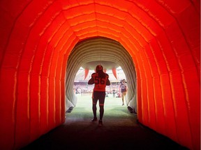B.C. Lions' Solomon Elimimian stands in an inflatable tunnel as he's introduced before a CFL football game against the Calgary Stampeders in Vancouver on August 18, 2017. Solomon Elimimian has had seasons end in titles and heartbreak, awards and devastating injuries. What he hasn't experienced is a year like 2017.
