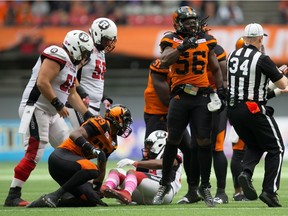 B.C. Lions' Solomon Elimimian (56) celebrates after tackling Ottawa Redblacks' William Powell, bottom, during the first half of Saturday's game at B.C. Place. He wasn't feeling so happy after the game, which saw the Lions outscored 24-0 in down the home stretch.