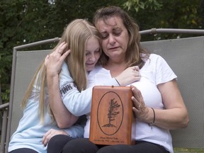 Denise Lane and her daughter, Megan, sit with the urn containing the ashes of her son Shawn in Innisfil, Ont. on Oct. 6. Denise Lane searches her mind for fond memories of her son, but she has trouble retrieving them. No Christmases, no birthdays. It's hard to remember the good times. Shawn Kelly Jr. died of a fentanyl overdose in Innisfil, Ont., about an hour's drive north of Toronto.