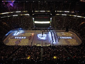 The names of the 58 people killed at the Route 91 Harvest country music festival are projected on the ice before the Vegas Golden Knights' inaugural regular-season home opener against the Arizona Coyotes at T-Mobile Arena on Tuesday in Las Vegas.