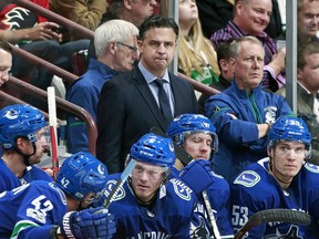 Head coach Travis Green of the Vancouver Canucks looks on from the bench during their NHL game against the Calgary Flames at Rogers Arena October 14, 2017.