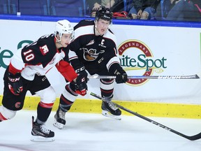 Tyler Benson of the Vancouver Giants plays the puck against Josh Curtis of the Prince George Cougars during the first period of their WHL game at the Langley Events Centre Friday.