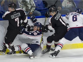 Vancouver Giants' Ty Ronning (7) and Brad Morrison (10) tangle with Tri-City Americans' Dylan Coghlan (10) and Juuso Vakimaki (6) along the boards during a WHL game at the LEC in Langley on Oct. 6.