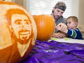 VANCOUVER. October 27 2017. Vancouver Canucks Christopher Tanev helps Gibson carve a pumpkin at Canuck Place to celebrate Halloween, Vancouver, October 27 2017.