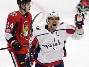 Washington Capitals left wing Alex Ovechkin (8) celebrates his third goal of the game as Ottawa Senators centre Jean-Gabriel Pageau (44) looks on during third period NHL hockey action in Ottawa on Thursday, October 5, 2017.