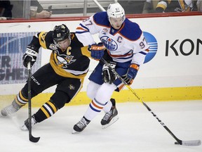Edmonton Oilers centre Connor McDavid (right) tries to fend off the Pittsburgh Penguins' Sidney Crosby during their Nov. 8, 2016 NHL game in Pittsburgh.