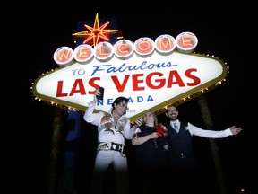 In this Tuesday, Oct. 3, 2017 photo, Elvis tribute artist Eddie Powers poses for a photo with newlyweds Rob and Kelly Roznowski after he married them at the Welcome to Las Vegas sign in Las Vegas. A gunman opened fire on an outdoor music concert on Sunday making it the deadliest mass shooting in modern U.S. history. But even though the city is in mourning, for many it is business as usual with celebrations and parties continuing. (AP Photo/Chris Carlson) ORG XMIT: NVSM201

TUESDAY, OCT. 3, 2017 PHOTO
Chris Carlson, AP