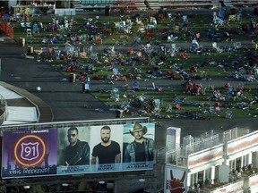 FILE - In this Tuesday, Oct. 3, 2017, file photo, personal belongings and debris litters the Route 91 Harvest festival grounds across the street from the Mandalay Bay resort and casino in Las Vegas.