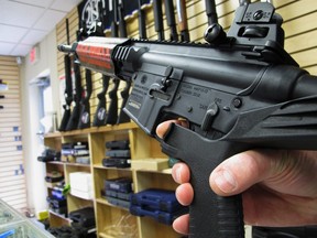 In this Feb. 1, 2013, file photo, an employee of North Raleigh Guns demonstrates how a "bump" stock works at the Raleigh, N.C., shop. The gunman who unleashed hundreds of rounds of gunfire on a crowd of concertgoers in Las Vegas on Monday, Oct. 2, 2017, attached what is called a "bump-stock" to two of his weapons, in effect converting semiautomatic firearms into fully automatic ones.