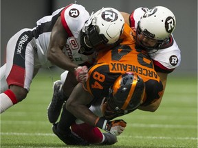Emmanuel Arceneaux is brought down by a pair of Ottawa Redblacks in the Lions' 30-25 loss at B.C. Place Stadium Saturday afternoon.